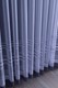 Knitted curtain with grey motif